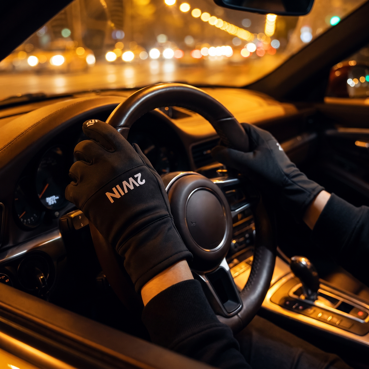 2WIN gloves on the steering wheel during a night drive